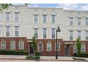Attractive townhome featuring a brick base, multiple windows, and well-maintained greenery at 306 Masons Row, Marietta, GA 30060
