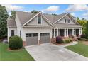 Charming single-Gathering home with a two-car garage, manicured lawn, and a classic facade under a cloudy sky at 3157 Perimeter Cir, Buford, GA 30519