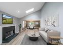 Bright living room with vaulted ceiling, fireplace, and seamless flow into the dining area at 4228 Lakes End Nw Dr, Kennesaw, GA 30144