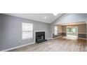 Spacious living room features a cozy fireplace, light-filled windows, and sleek flooring at 4228 Lakes End Nw Dr, Kennesaw, GA 30144