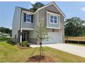 Charming two-story home with brick and siding exterior and a two-car garage at 45 Avian Way, Auburn, GA 30011