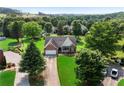 Aerial view of single-Gathering home, showcasing manicured lawn, mature trees and proximity to lush, green surroundings at 16 Kentucky Ne Walk, Cartersville, GA 30121