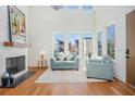 Bright living room with soaring ceilings, large windows, and a cozy seating area at 165 Breakspear Ln, Fayetteville, GA 30214