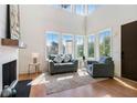 Bright living room with soaring ceilings, large windows, and a cozy seating area at 165 Breakspear Ln, Fayetteville, GA 30214