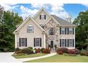 Beautiful home with stone facade, manicured lawn, and colorful mature landscaping at 4651 Oakleigh Manor Dr, Powder Springs, GA 30127