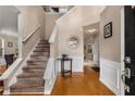 Inviting foyer with hardwood floors, staircase, and elegant wainscoting at 1355 Pinebreeze Way, Marietta, GA 30062
