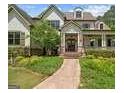 Close up of a charming two-story home with a manicured front yard, inviting porch, and mature landscaping at 193 Stonegate Trl, Carrollton, GA 30116