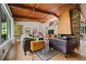 Bright living room featuring a unique fireplace, wood ceiling, tile floors and large windows at 3408 Chestnut Dr, Doraville, GA 30340