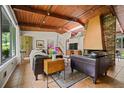 Bright living room featuring a vaulted ceiling, fireplace, and large windows at 3408 Chestnut Dr, Doraville, GA 30340