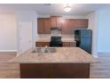 Kitchen with island sink, ample counter space, updated cabinets, and black appliances at 1531 Iris Walk, Jonesboro, GA 30238