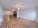 Spacious living area featuring hardwood floors and open floor plan to the kitchen at 1531 Iris Walk, Jonesboro, GA 30238