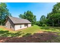 Spacious backyard featuring a well-maintained lawn extending to a wooded area, ideal for outdoor activities and relaxation at 1960 York Dr, Canton, GA 30114