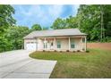 Inviting one-story home with a manicured lawn, concrete driveway, and attached garage, creating a welcoming curb appeal at 1960 York Dr, Canton, GA 30114