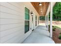 Charming covered porch with wood ceiling, featuring stylish lighting fixtures and ample space for outdoor seating at 1960 York Dr, Canton, GA 30114