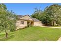 Charming home features a manicured lawn and a two-car garage at 3792 Refinement Way, Douglasville, GA 30135