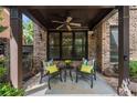 Cozy back porch with ceiling fan, brick pillars, and comfortable seating, perfect for relaxing outdoors at 625 Society St, Alpharetta, GA 30022