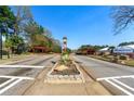 Mainstreet community entrance featuring a clock tower, red arbors, and manicured landscaping at 801 Arbor Hill Dr, Stone Mountain, GA 30088