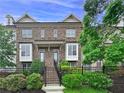 Elegant brick townhome featuring a well-maintained front yard and classic architectural details at 1094 Township Sq, Alpharetta, GA 30022
