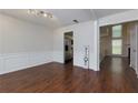 Spacious dining room with hardwood floors, and elegant wainscoting detail at 306 Burdock Trce, Woodstock, GA 30188