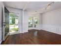 Inviting living room with lots of natural light, white walls, and hardwood floors at 306 Burdock Trce, Woodstock, GA 30188