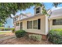 Exterior view of home showcasing the side entrance, neat landscaping and black shutters at 5509 Park S Pl, Atlanta, GA 30349