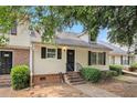 Charming townhome with a welcoming entrance, well-maintained landscaping, and black shutters at 5509 Park S Pl, Atlanta, GA 30349