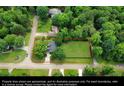 An aerial view of a home with a large grassy yard and mature trees at 1206 Red Fox Cir, Woodstock, GA 30188