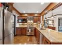 Bright eat-in kitchen with stainless steel appliances, granite countertops, and dark wood cabinets at 1206 Red Fox Cir, Woodstock, GA 30188