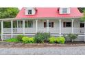 Eye-level of porch with white railings, and foundation landscaping under a red roof with dormer windows at 1365 Lower Creighton Rd, Cumming, GA 30028