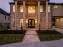 Charming brick home featuring a grand entrance with stately pillars and manicured landscaping at 157 Shadburn Ferry Rd, Buford, GA 30518