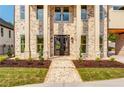Charming brick home featuring a grand entrance with stately pillars and manicured landscaping at 157 Shadburn Ferry Rd, Buford, GA 30518