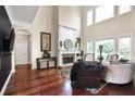 Spacious living room boasting a stone fireplace, hardwood floors, tall ceilings, and plenty of natural light at 931 Hidden Falls Se Ln, Smyrna, GA 30082