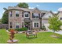 Beautiful two-story home with brick and siding, green lawn, mature landscaping and welcoming front porch at 3126 Cove View Ct, Dacula, GA 30019