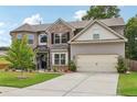 Two-story home with brick and siding, mature landscaping, driveway, and attached two-car garage at 3126 Cove View Ct, Dacula, GA 30019