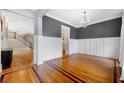 Elegant dining room featuring hardwood floors, wainscoting, and a stylish chandelier at 1122 Parkview Pl, Smyrna, GA 30080