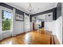 Bright living room with hardwood floors, large windows, and elegant wainscoting details at 1122 Parkview Pl, Smyrna, GA 30080