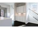 Eat-in kitchen features a built-in cabinet and a staircase to the upper level of the home at 1110 Bakary Ct, Decatur, GA 30032