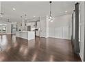 Spacious living room and kitchen featuring hardwood floors and modern lighting fixtures at 1110 Bakary Ct, Decatur, GA 30032