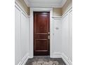 Elegant entry door with dark wood finish and classic trim, complemented by neutral wall colors at 1717 N Decatur Ne Rd # 117, Atlanta, GA 30307