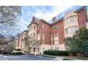Exterior of the building showcasing brick and light stone facade with well-maintained landscaping around the property at 1717 N Decatur Ne Rd # 117, Atlanta, GA 30307