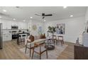 Open-concept living room with modern decor and plenty of natural light connecting the kitchen and living areas at 3634 Oakleaf Pass, Fairburn, GA 30213