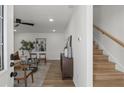 Light and airy living room with modern decor, hardwood floors, and a staircase leading to the upper level at 3634 Oakleaf Pass, Fairburn, GA 30213