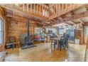 Open-concept living area featuring wood walls, floors and wood burning fireplace at 519 E Valley Ne Rd, Rydal, GA 30171