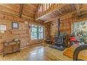 Cozy living room featuring wood walls, floors and wood burning fireplace at 519 E Valley Ne Rd, Rydal, GA 30171