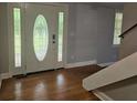 Well-lit foyer featuring an elegant front door, hardwood flooring, and staircase at 8291 Highway 5, Whitesburg, GA 30185