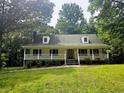 Charming single-story home with a welcoming front porch and well-manicured lawn at 8291 Highway 5, Whitesburg, GA 30185