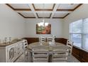 Elegant dining room with coffered ceilings, wainscoting, and a chandelier creating an inviting atmosphere at 893 Whitfield Oak Rd, Auburn, GA 30011