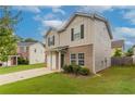 Two-story home with stone accents, an attached garage, manicured landscaping, and a concrete driveway at 12039 Quail Dr, Hampton, GA 30228