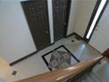 Elegant foyer featuring a decorative tiled floor and a wooden staircase at 4576 Creek Forestt Trl, Lilburn, GA 30047