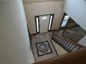 Elegant foyer featuring a decorative tiled floor, a wooden staircase, and a front door with glass accents at 4576 Creek Forestt Trl, Lilburn, GA 30047